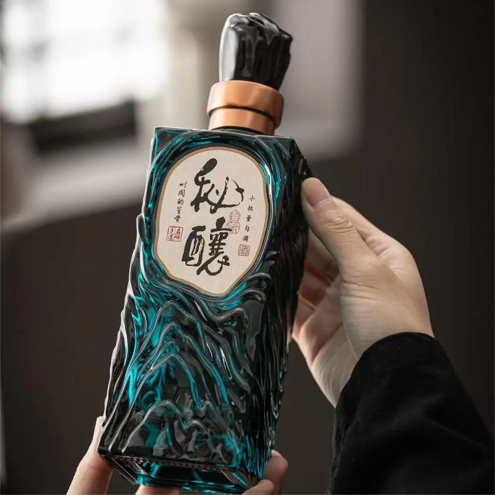Shang Art G21 sculpted square glass liquor bottle held during a physical product review